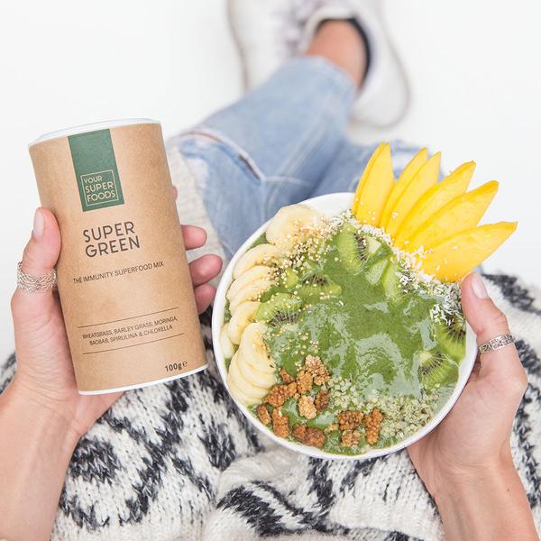 lady holding bowl of breakfast bowl with your superfoods super green 