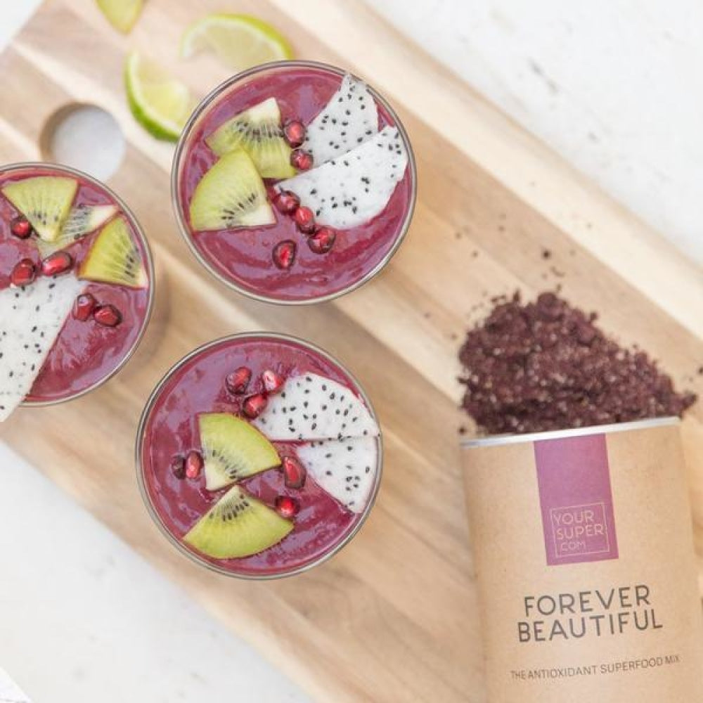 your superfoods forever beautiful smoothie in mason jars, recipe with dragon fruit, kiwi and pomegranate 
