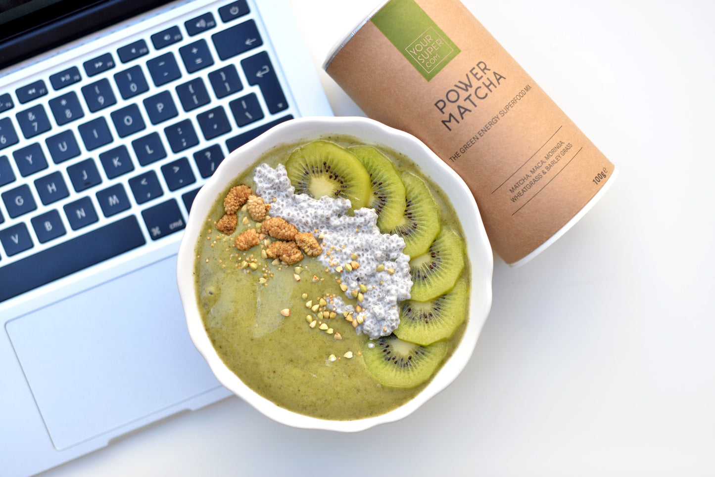 breakfast bowl of your superfoods power matcha sitting on macbook pro keyboard 